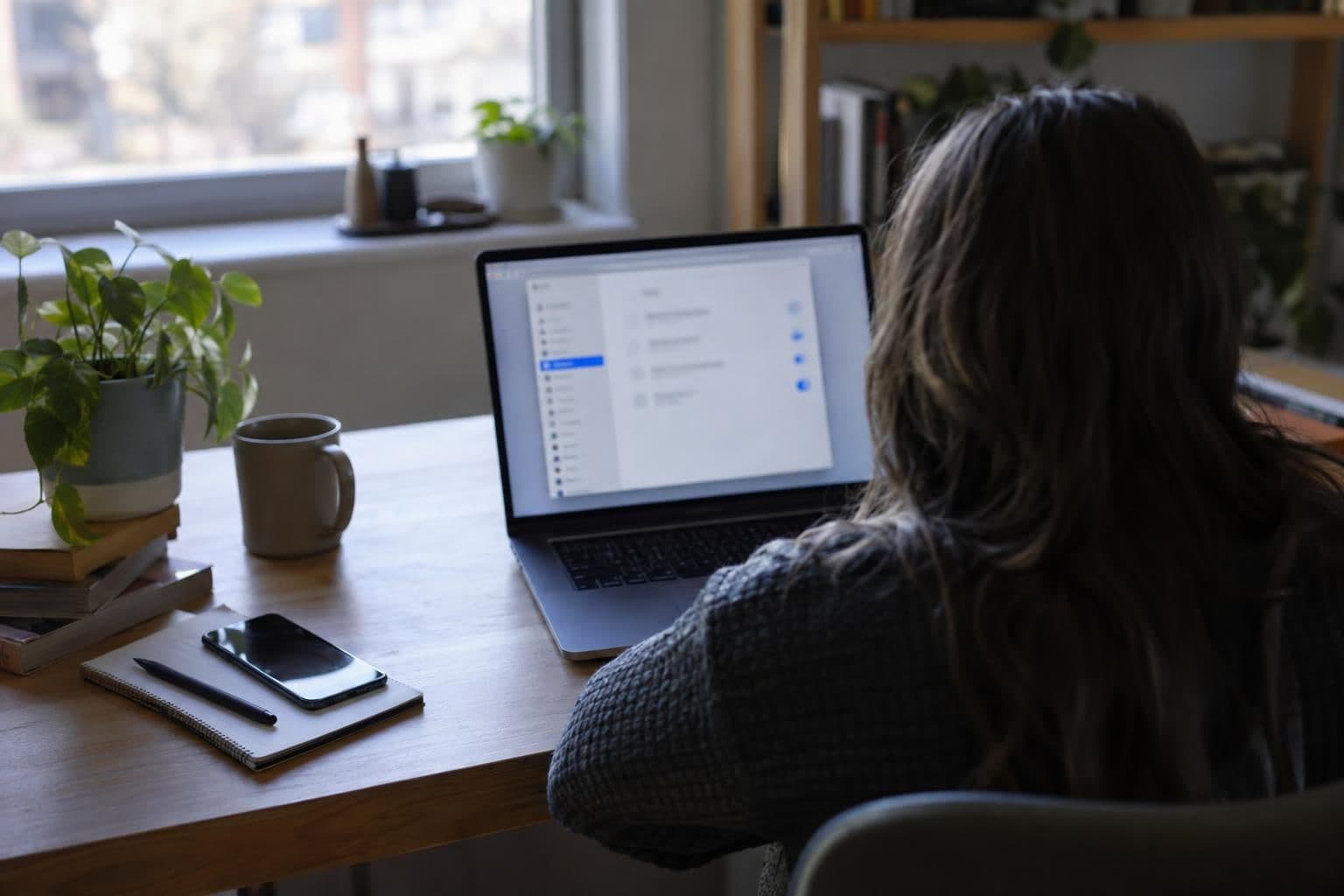 A laptop user reviews privacy settings at a desk.