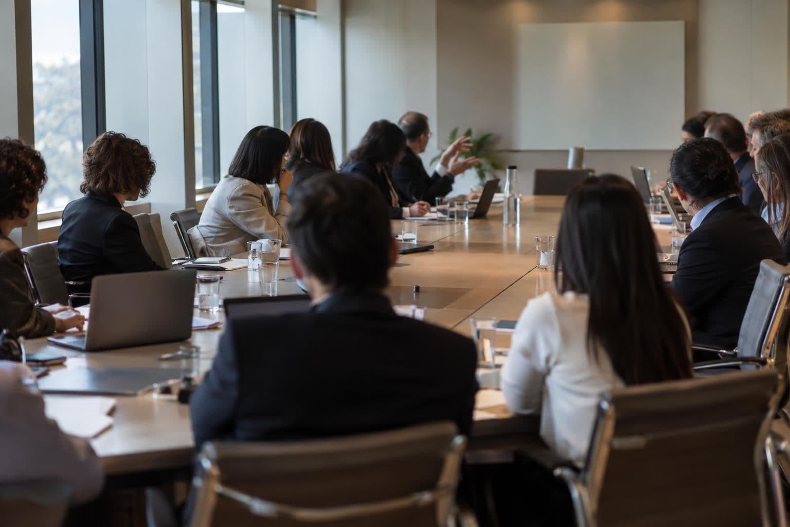 Anonymous delegates discuss international AI rules around a conference table.