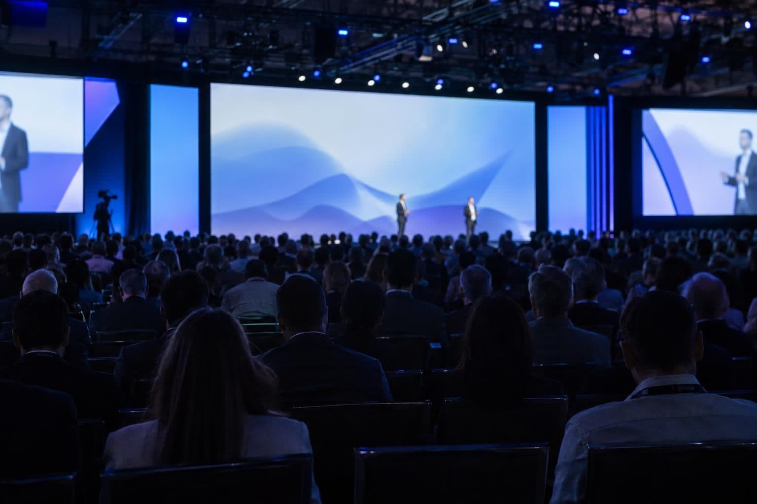 Anonymous presenters address an audience at SAP Connect, where Joule Work was presented.