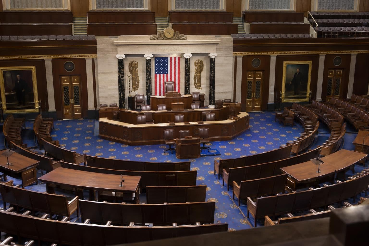 An empty U.S. House chamber seen from the public gallery.