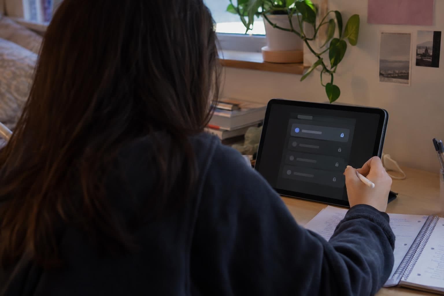 A student studies beside a tablet showing one available model choice.