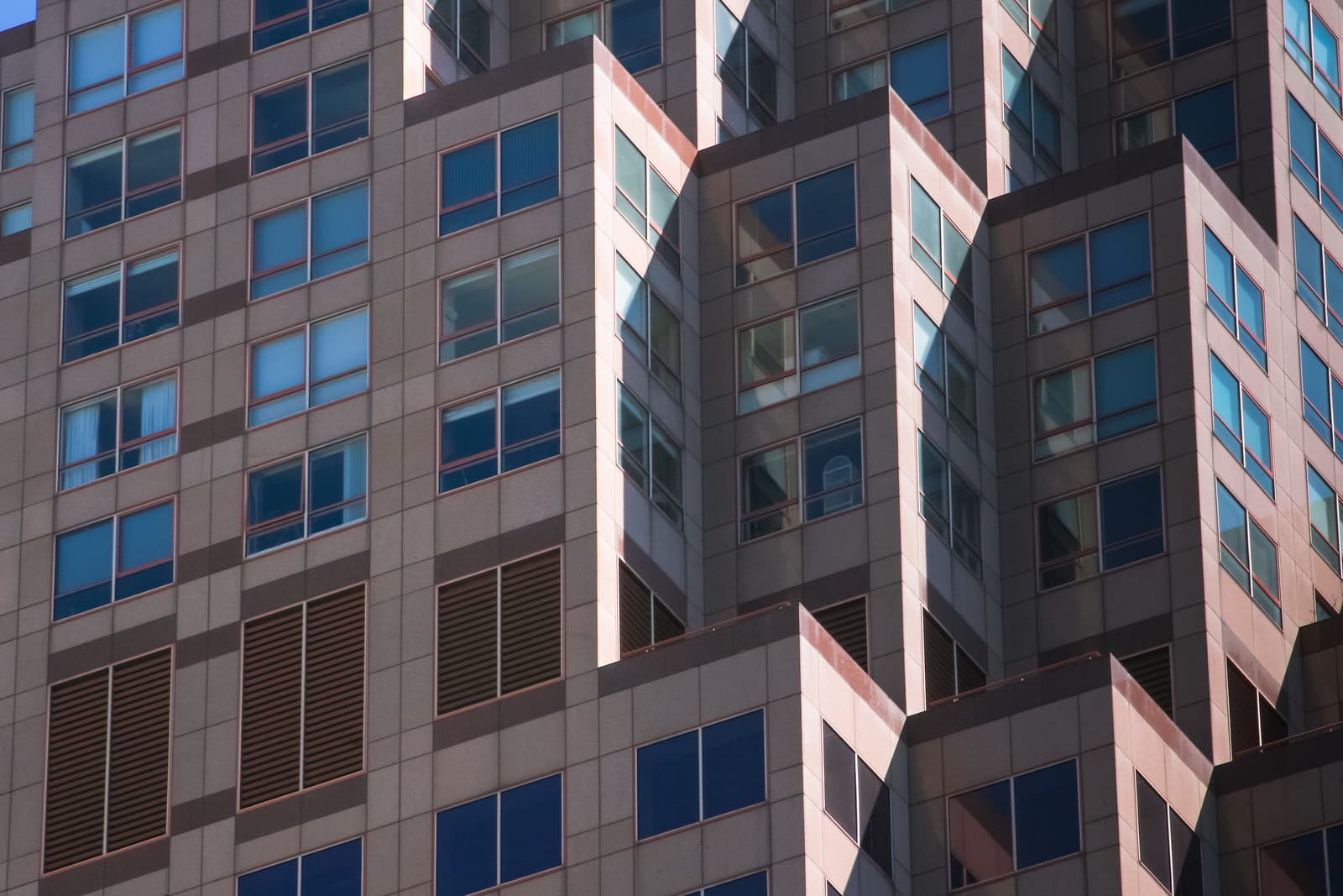 This is an abstract shot of the top of 333 Bush Street skyscraper in San Francisco.